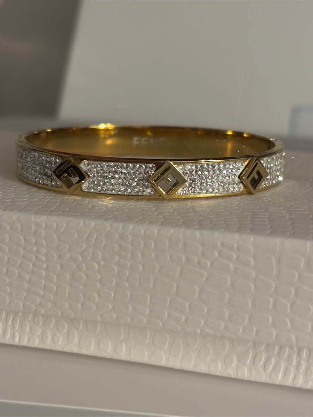 Gold-tone Pavé Crystal Logo Bangle in Gold and Clear